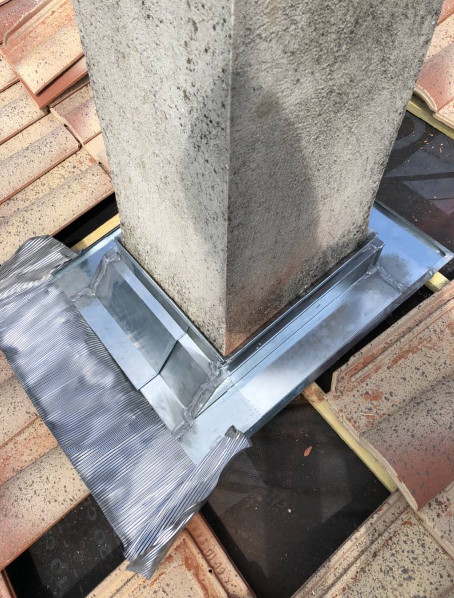 Pied de cheminée en zinc adaptable réalisé par notre équipe de couvreurs pendant un changement de toiture